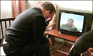 Naval officer watching TV